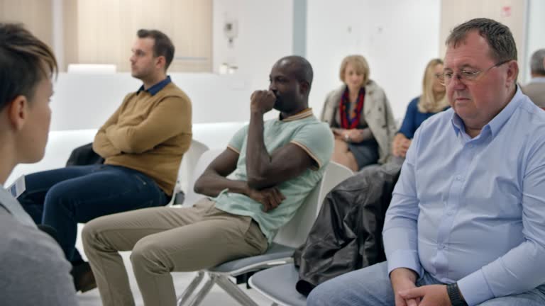 DS Patient sitting in a big waiting room in the hospital