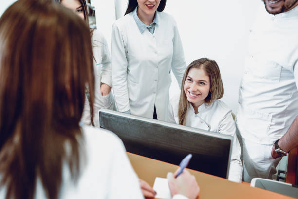 istock Medical Team is Making Appointment With a Patient For a Dental Check Up 932375582
