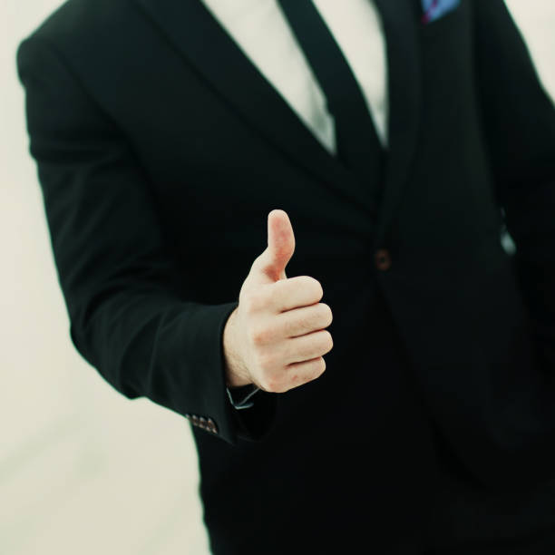 istock businessman making a gesture - thumbs up on white background 932380816