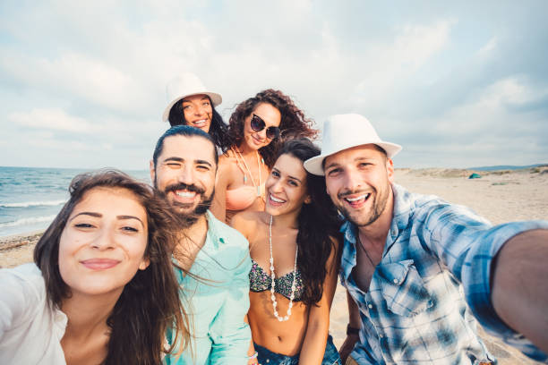 istock Friends taking selfie at beach 932381146