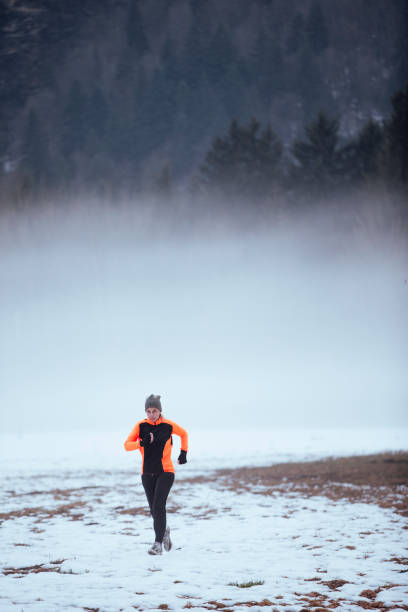 istock Woman Running in the Snow 932383892