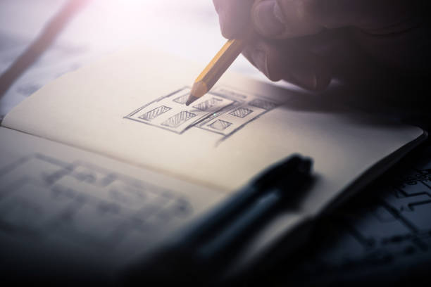 istock Close-up of an architect hand drawing a building 932384770