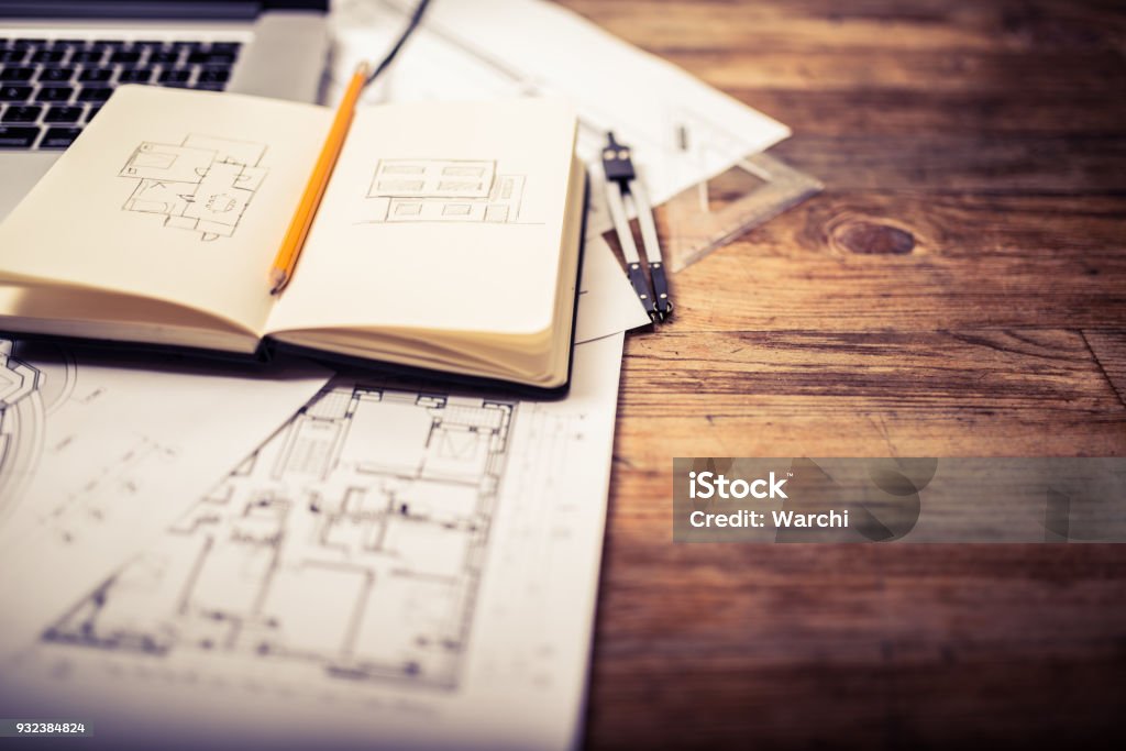 Architects desk Open notepad on an architect desk showing a hand drawn facade and plan Architect Stock Photo