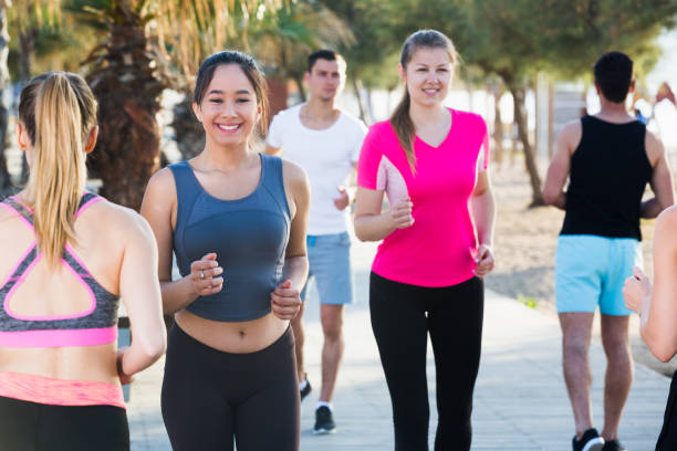 istock People running along embankment 932386794