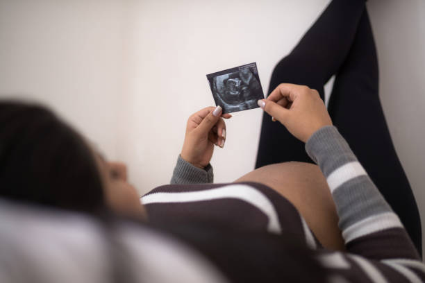 istock Pregnant woman watching her son's ultrasound 932392814
