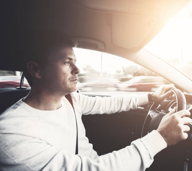istock Man driving car in the city 932393786