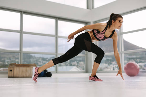 istock Female doing stretching workout in health center 932396488
