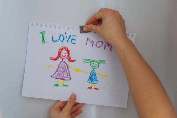 istock children's drawing on fridge. I love mom. 932408852