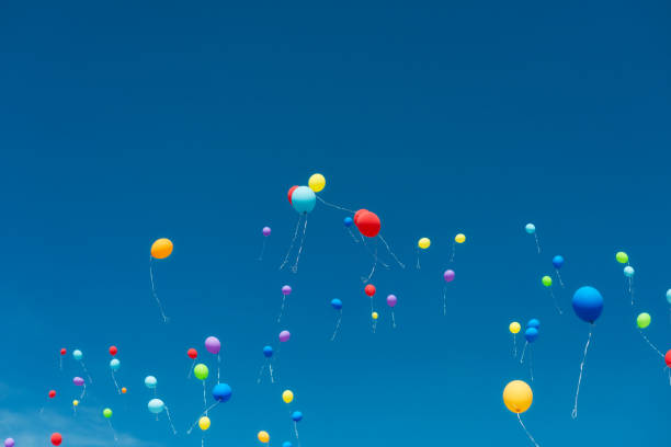 istock copy space on a blue sky with balloons rising 932412536
