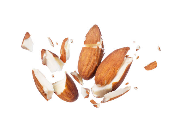 Almonds is torn to pieces close-up, isolated on white background Almonds is torn to pieces close-up, isolated on white background almond slivers stock pictures, royalty-free photos & images