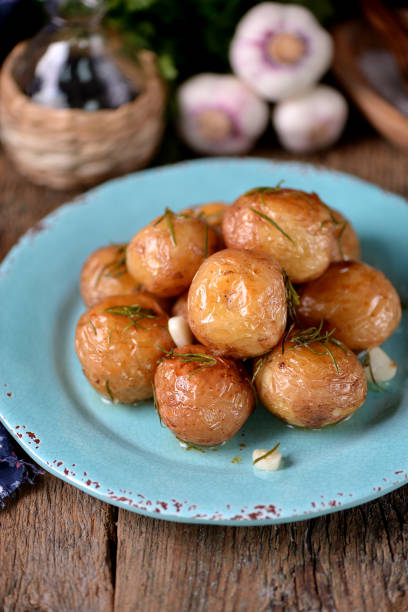 istock Baked golden whole potatoes with olive oil 932416412