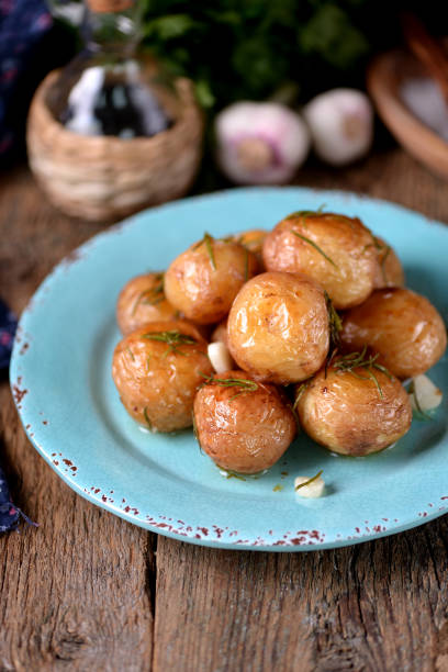 istock Baked golden whole potatoes with olive oil 932416432