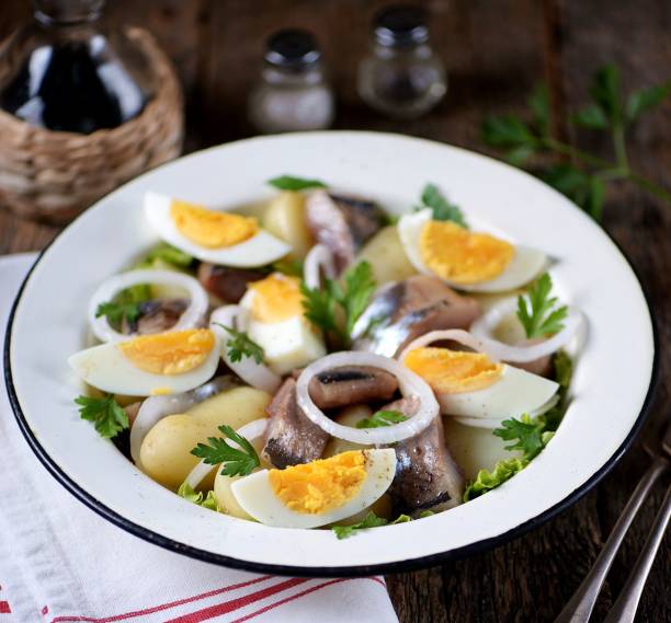 istock Salad from light-salted herring, boiled potatoes, eggs and onions 932417368