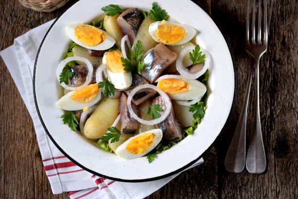 istock Salad from light-salted herring, boiled potatoes, eggs and onions 932417376