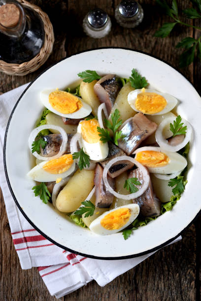 istock Salad from light-salted herring, boiled potatoes, eggs and onions 932417450