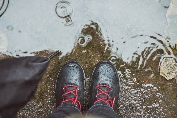 istock Looking down at a puddle of water during a rainy day 932421344