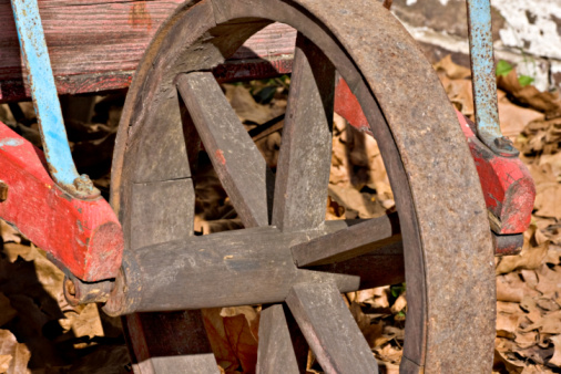 A closeup of an old wheelbarrow wheel in Allaire Village, New Jersey. Allaire village was a bog iron industry town in New Jersey during the early 19th century.