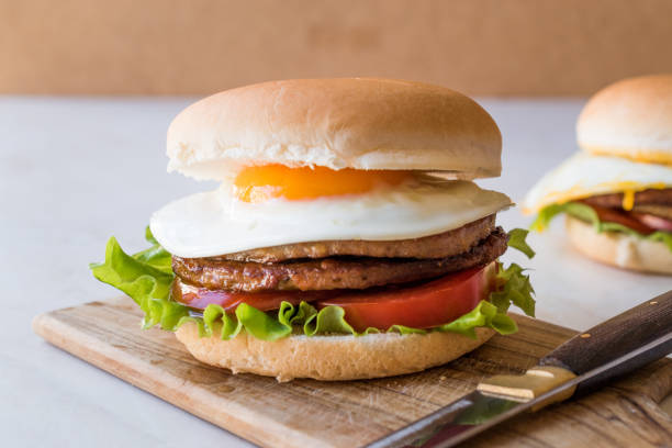 istock Homemade Double Hamburger with Egg, Lettuce and Tomatoes. 932437044