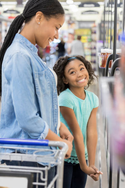 istock Girl asks her mom for ice cream in grocery store 932439954