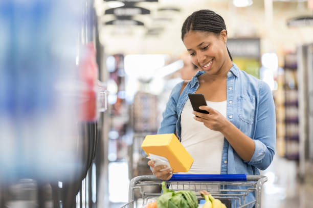istock Woman uses grocery store mobile app while shopping 932439974