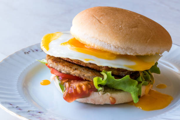 istock Homemade Double Hamburger with Egg, Lettuce and Tomatoes. 932440826