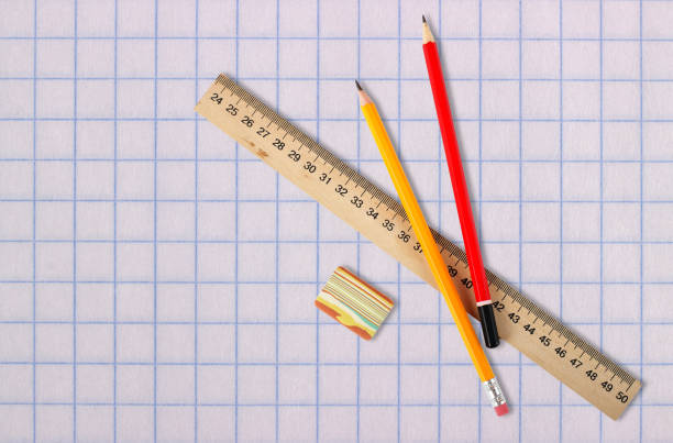 istock Stationery - Ruler, eraser and pencils school paper background 932444174