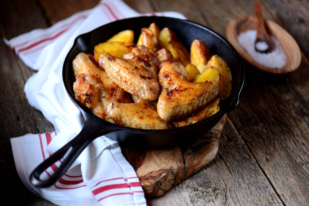 istock Chicken wings baked with potatoes 932445602