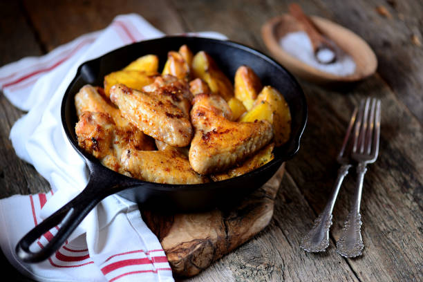 istock Chicken wings baked with potatoes 932445646