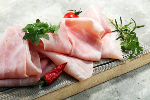 istock Sliced ham on wooden background. Fresh prosciutto. Pork ham sliced 932448634