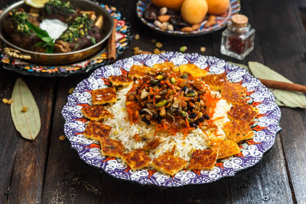 Delicious Iranian jewelled rice topped with nuts, raisins and orange zest stock photo