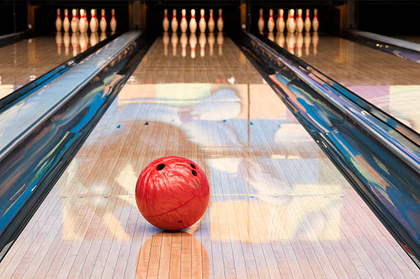 Red bowling ball sitting in middle of newly oiled lane Bowling ball with pins bowling alley stock pictures, royalty-free photos & images