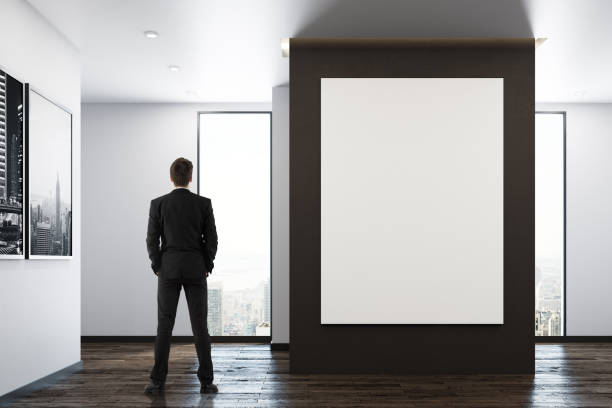 istock Man in room with poster 932459268