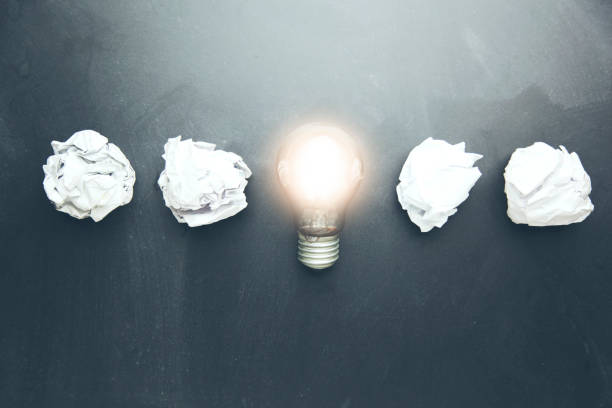 istock new idea concept with crumpled office paper and light bulb 932466786