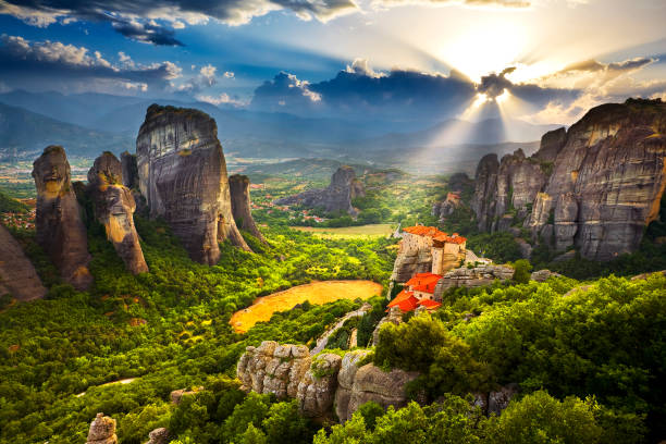 Meteora, sunset scenery Greece. Meteora - incredible sandstone rock formations rise from the ground and the monasteries on the top of rocks. The Holly Monastery of Rousanou and St. Nikolaos Anapafsas Monastery in the background. The Meteora area is on UNESCO World Heritage List since 1988 meteora stock pictures, royalty-free photos & images
