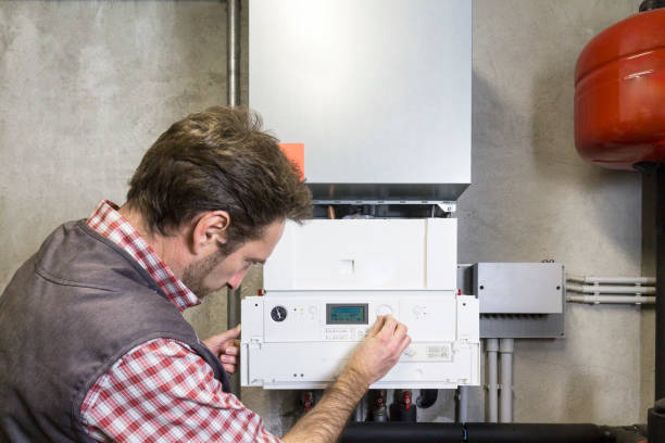 istock plumber repairing a condensing boiler 932470106