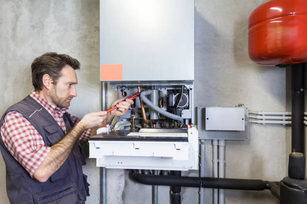 istock plumber repairing a condensing boiler 932471774
