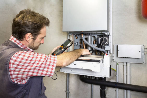 istock plumber repairing a condensing boiler 932472478