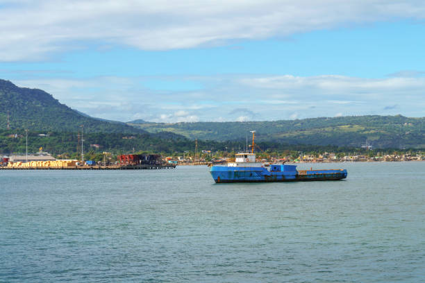 istock floating on the river barge against the cargo port 932475368