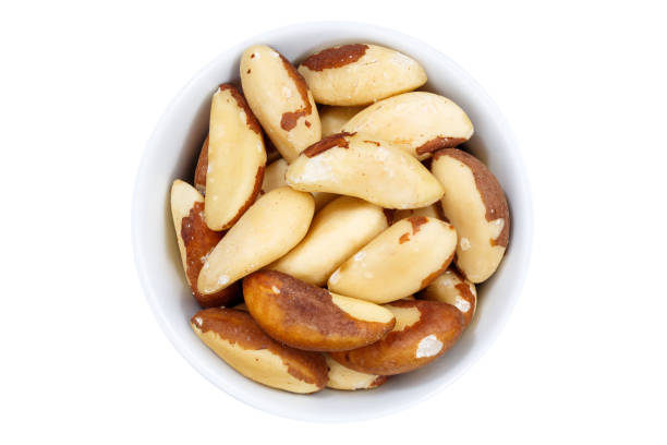 istock Brazil nut nuts from above bowl isolated on white 932477754