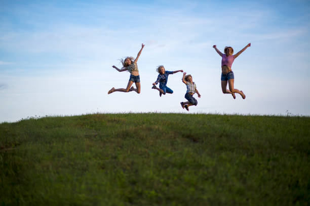 istock Mother and children jumping 932478008