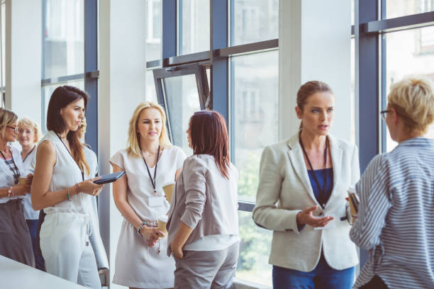 Seminar for woman, women discussing during coffee break Women at conference. Group of women discussing during coffee break. woman press conference stock pictures, royalty-free photos & images