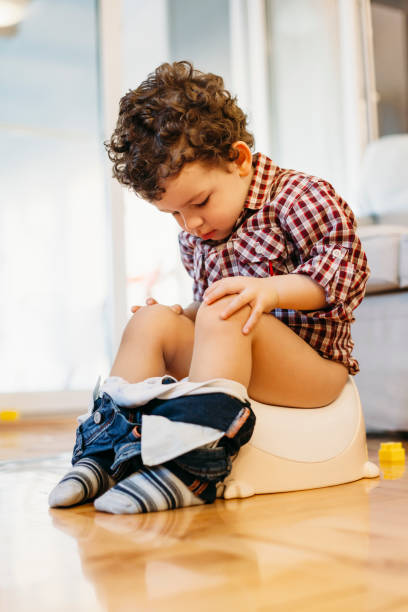 istock Little boy sitting on potty 932478904