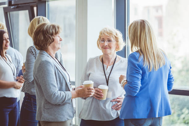 istock Mature women discussing during coffee break on seminar 932483312