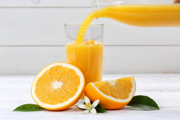 istock Orange juice pouring pour oranges fruit fruits 932483566