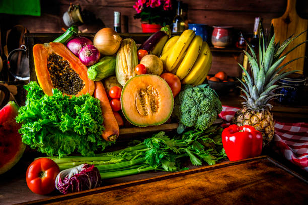 istock Cutting board in a rustic kitchen ready to cut and process organic tropical fruits and vegetables. Natural lighting 932487162