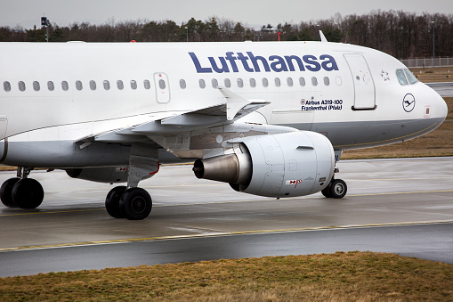 Airbus A319-100 of German airline Lufthansa is taxiing on runway Northwest at Frankfurt Airport on a rainy afternoon. Lufthansa is one of the leading airlines in the world.