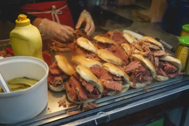 Traditional bagels with hot salt beef prepared in a bakery in Brick Lane in Bethnal Green. London (UK). Landscape format.