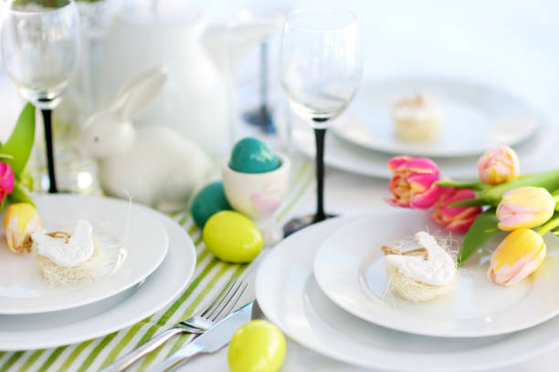 istock Beautiful table setting with crockery and flowers for Easter celebration 932506486