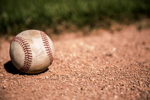 istock Baseball season is here.  Weathered ball on field. 932514856