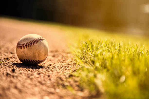 istock Baseball season is here.  Weathered ball on field. 932514898
